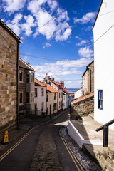 Fototapeta na wymiar Staithes, North Yorkshire, UK. A view looking down High Street towards the harbour.