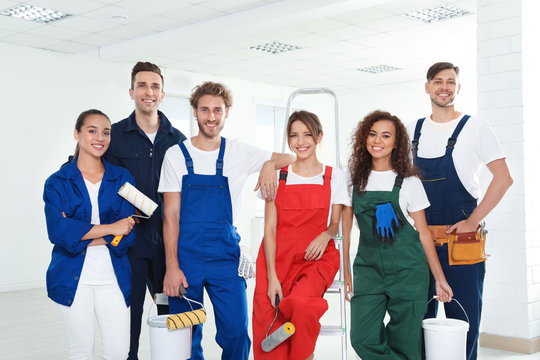 Team of professional painters with tools indoors
