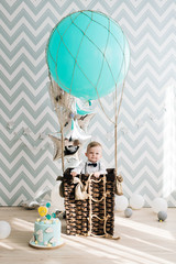 Baby's first birthday. Cute smiling baby is 1 year old. The concept of a children's party with balloons