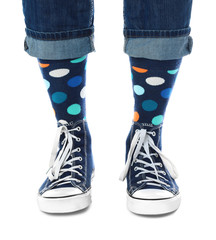 Person wearing stylish socks and shoes on white background, closeup