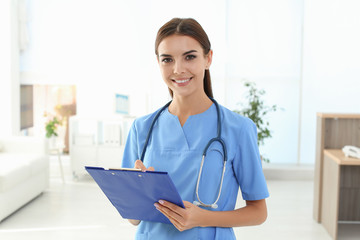 Female medical assistant in clinic. Health care service - obrazy, fototapety, plakaty