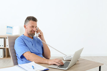 Male medical assistant at workplace in clinic. Health care service