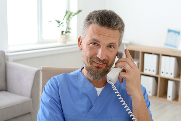 Male medical assistant working in clinic. Health care service