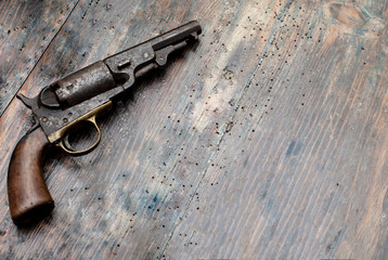 A historical pistols on vintage wooden table..