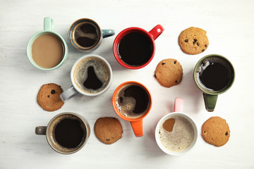Flat lay composition with cups of coffee on light background. Food photography