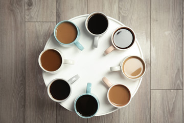 Cups of fresh aromatic coffee on light table, top view. Food photography