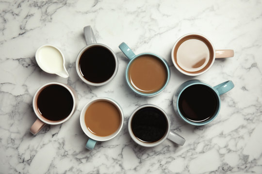 Flat lay composition with cups of coffee on marble background. Food photography