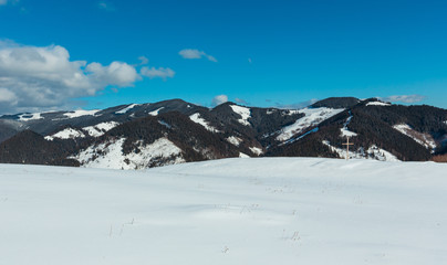 Fototapeta na wymiar Cross on winter mountain hill top