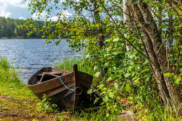 Old wooden rowing boat on the shore of the Saimaa lake in Finland - 1