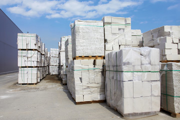 Defective aerated concrete blocks on pallets stored at warehouse