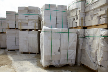 Defective aerated concrete blocks on pallets stored at warehouse