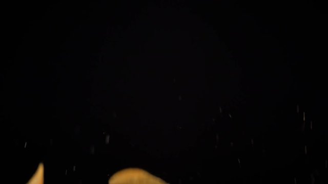 potato chips in free fall on a black background. Slow motion. The view from the side. Pringles