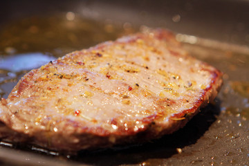 Up Close of Meat Cooking in a Pan