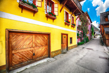 Scenic view of famous Hallstatt viilage. Typical Austrian Alpine houses with bright flowers