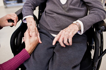 A Young Woman Holding an Older Person's Hand