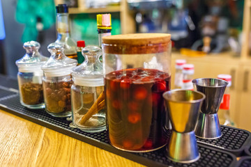 Bars of spices in an elite bar for making cocktails Cinnamon Rosehip Clove Drunk Cherry