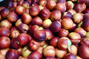 Fototapeta na wymiar Fresh bunch of peaches fruit at market on sale