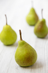 Fresh pears on a white wooden table, side view. Closeup.