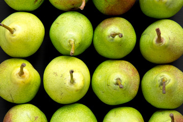 Tasty fresh pears on dark background, top view. From above, overhead, flat lay.