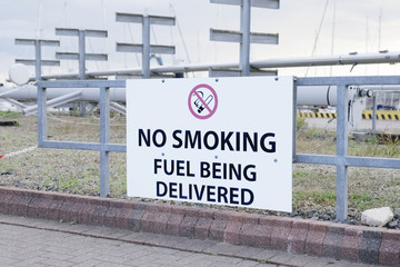 Fuel being delivered no smoking sign at oil and gas refinery