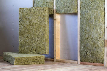 Wooden frame for future walls with drywall plates insulated with rock wool and fiberglass...