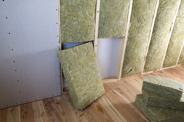 Wooden frame for future walls with drywall plates insulated with rock wool and fiberglass...