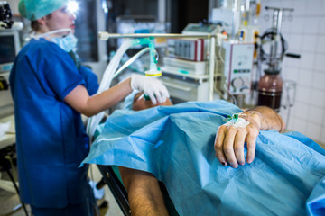 Unidentified boy undergoing a surgery. Focus on the monitor with vital functions