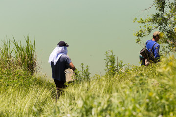 Fishermen go down to the river to find a good place for fishing