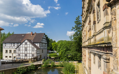 Fototapeta na wymiar Pond and half timbered house at the Brake castle in Lemgo, Germany