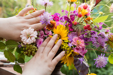 Professional florist hands make a wedding flowers bouquet 