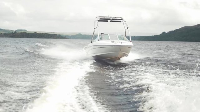 Speed boat tracking shot on lake