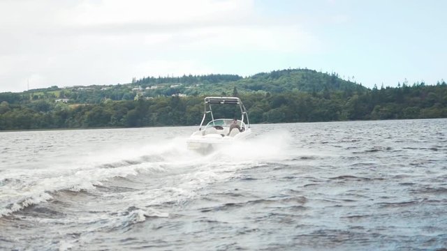 Speed boat tracking shot on lake