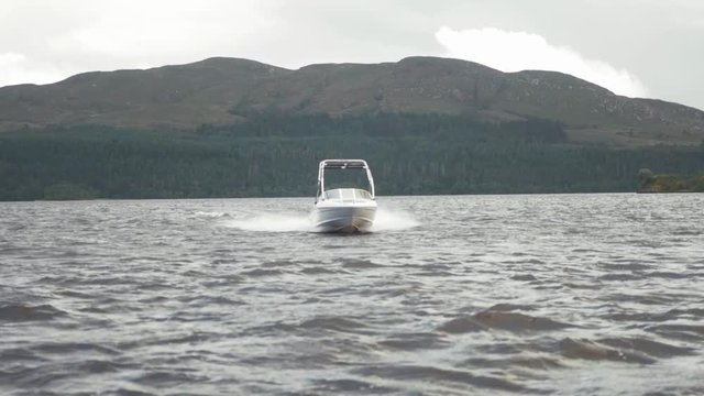 Speed boat tracking shot on lake