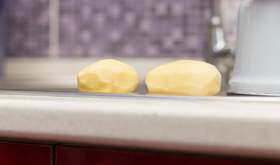 Peeled fresh potatoes in the kitchen sink