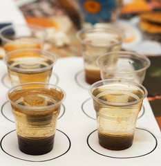 Dirty water, through filtration after cleaning on a plastic cup