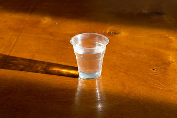 Dirty water, through filtration after cleaning on a plastic cup