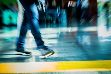 Closeup of People Walking in Airport Carrying Luggage