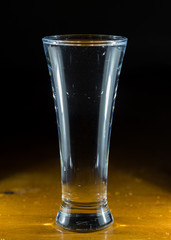 water, glass on a dark wooden background