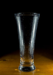 water, glass on a dark wooden background