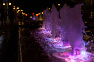 fountain with colorful illuminations at night