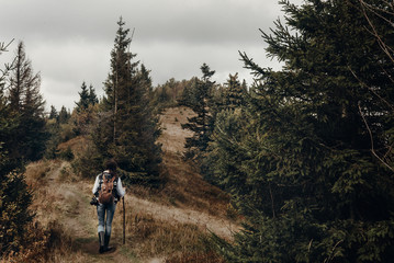 Obraz premium wanderlust and travel concept with space for text. hipster traveler on top of mountains, amazing view. stylish woman hiking. atmospheric moment