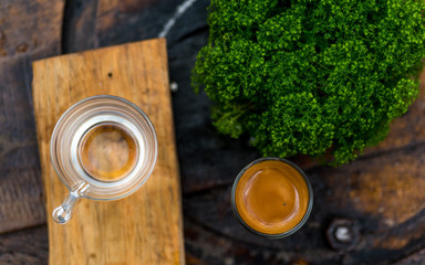Espresso coffee cup serve with glass of water on wooden table