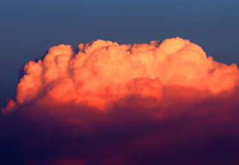 Magnificent colorful clouds in the evening sky. Bright, pink clouds in the sky at sunset. Beautiful evening skyscape. Abstract, purple pink background. Vibrant color photograph.