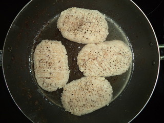 prepared for roasting chicken cutlets with spices in a frying pan
