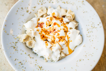 Turkish Mantı, traditional turkish food, sauce with yogurt on the turkish ravioli