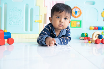 cute little asian baby boy lying on floor