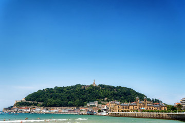 Scenery at San Sebastian Spain of Playa La Concha and the statue of Jesus on Monte Urgull
