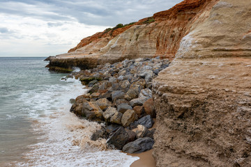 The eroding cliffs at Port Noarlunga and the protective rocks placed as a prevention method in...