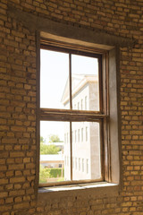 Fototapeta premium Old brick windows from inside the building and sunlight