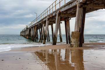 The iconic Port Noarlunga Jetty and its reflection in the water below locatedin South Australia on 23rd August 2018